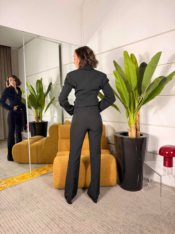 Pantalone nero a zampa con inserto in tessuto 